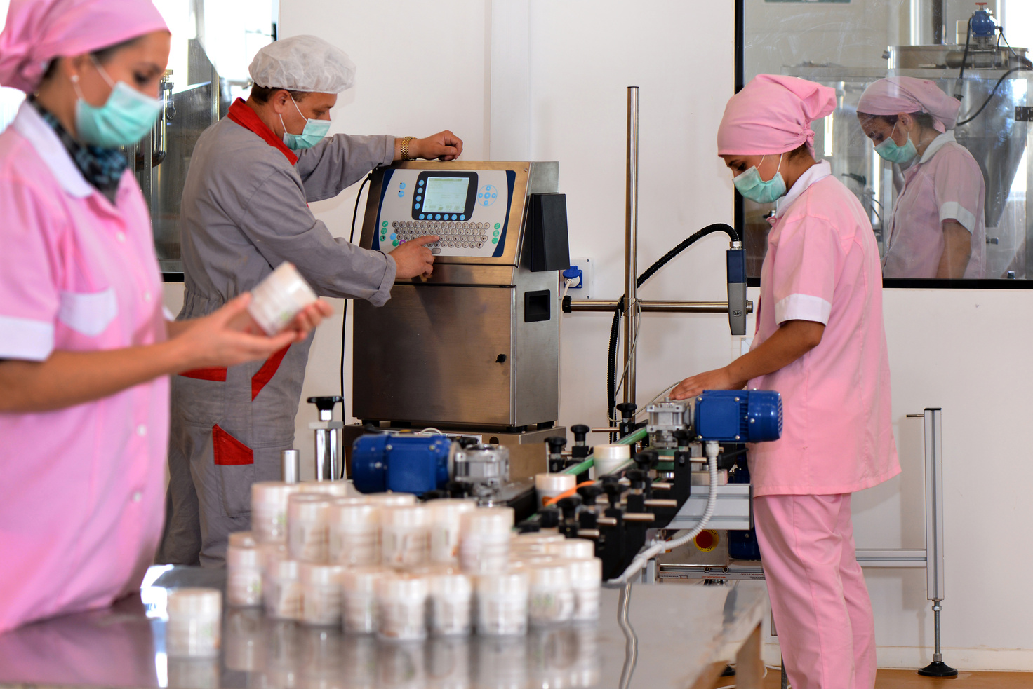 Production line workers in cosmetics factory